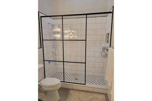 A photo of black gridded glass shower door in Novi, MI.