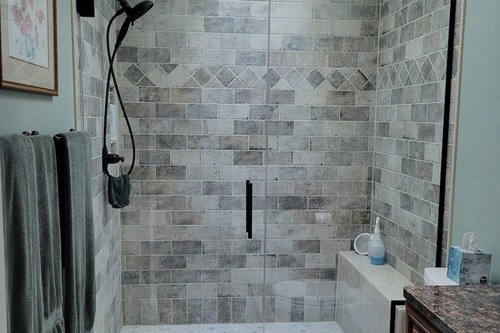 Photo of a glass shower door with custom tile. Part of a bathroom remodel in Novi, MI.